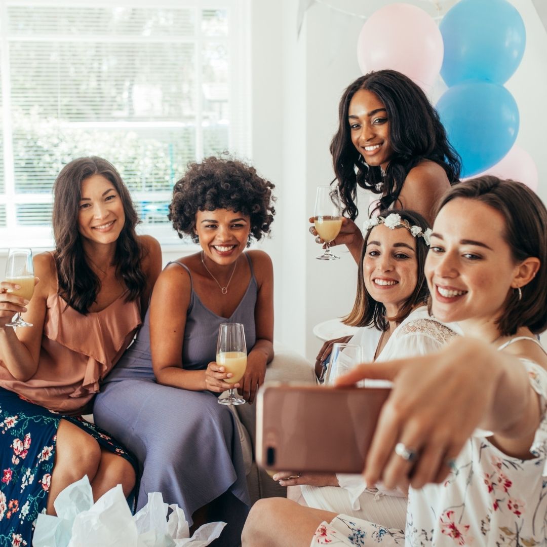 Group of mom friends drinking champagne and taking a selfie