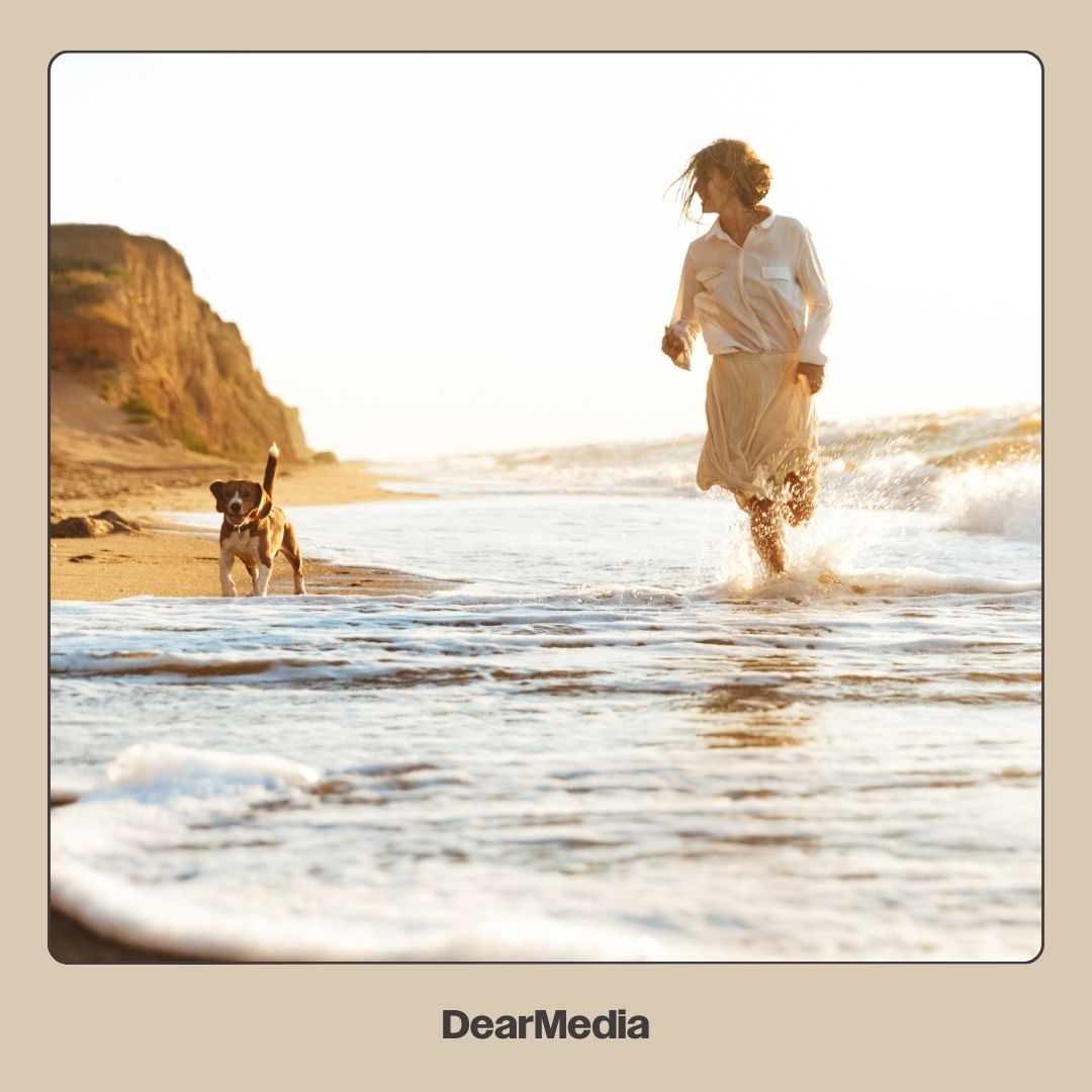 woman and dog at the beach